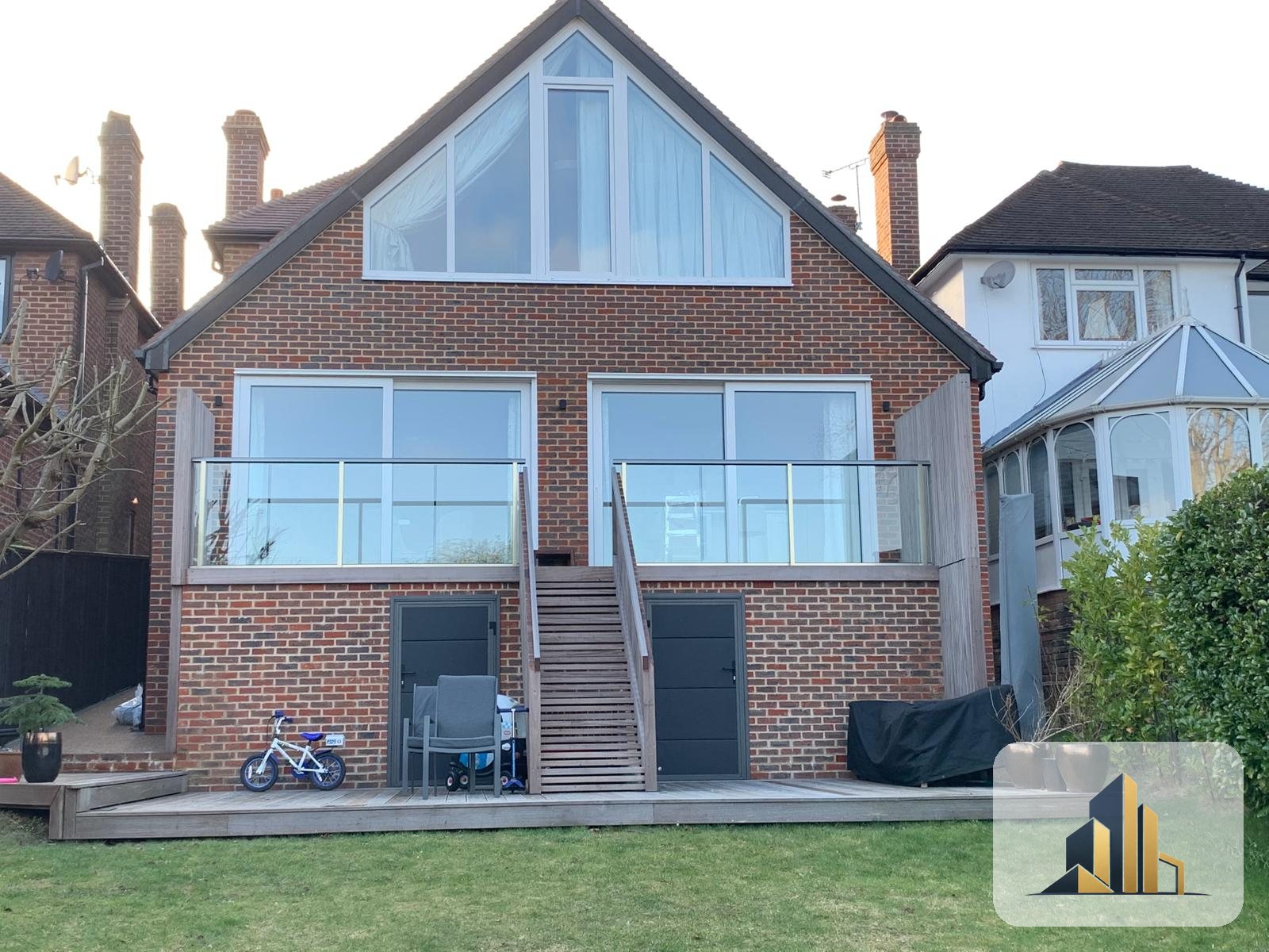 Completed two-storey rear extension with glass balcony, Banstead